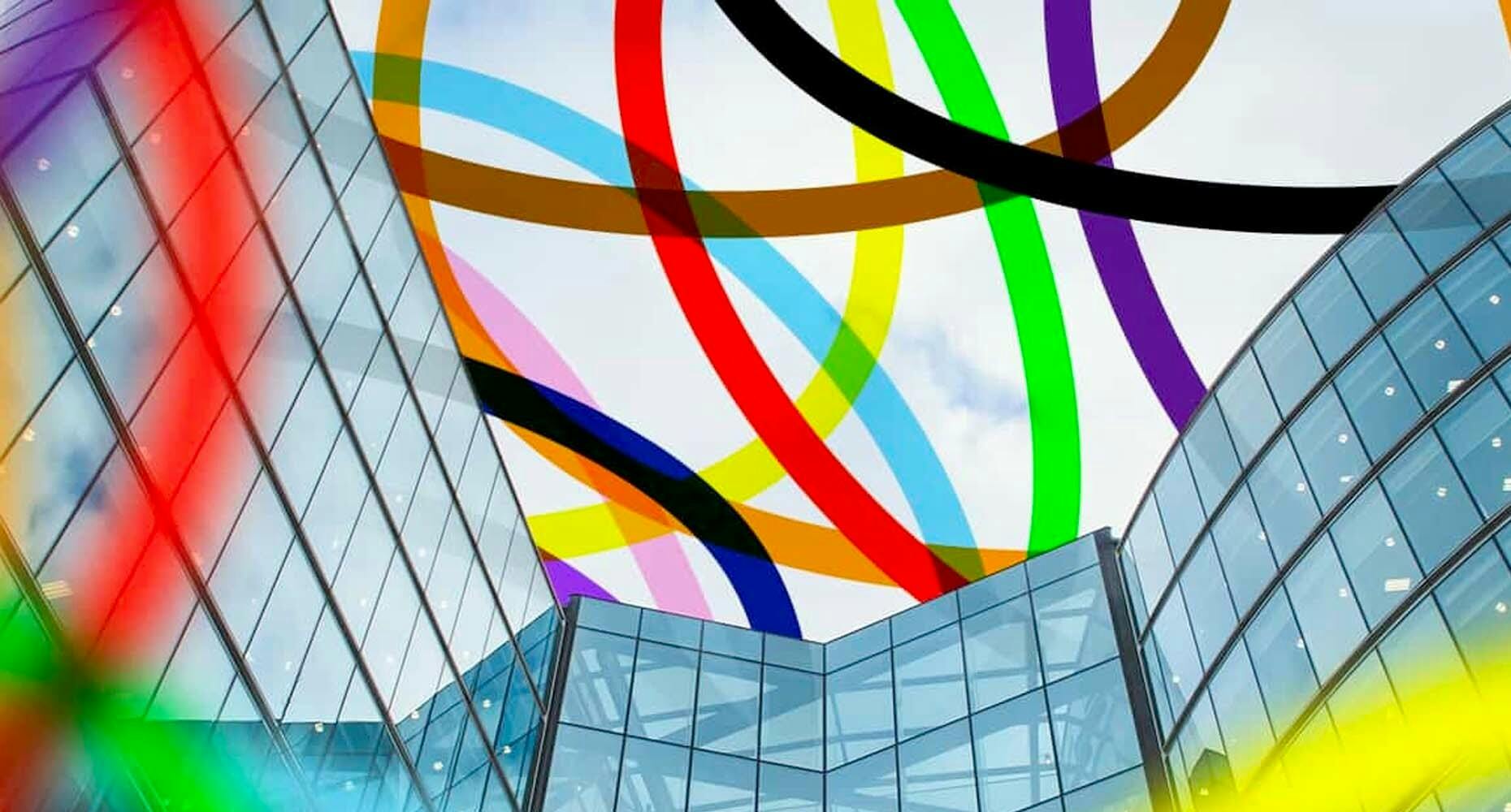 A vibrant rainbow arching over a modern glass building, symbolizing hope and positivity.