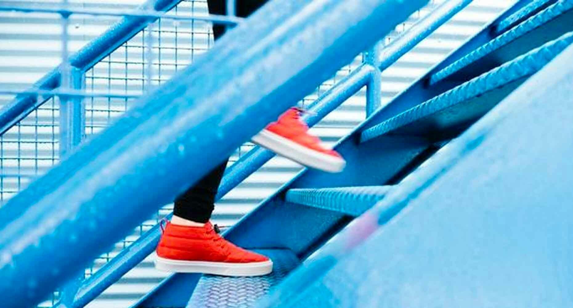 Red shoes going up blue stairs
