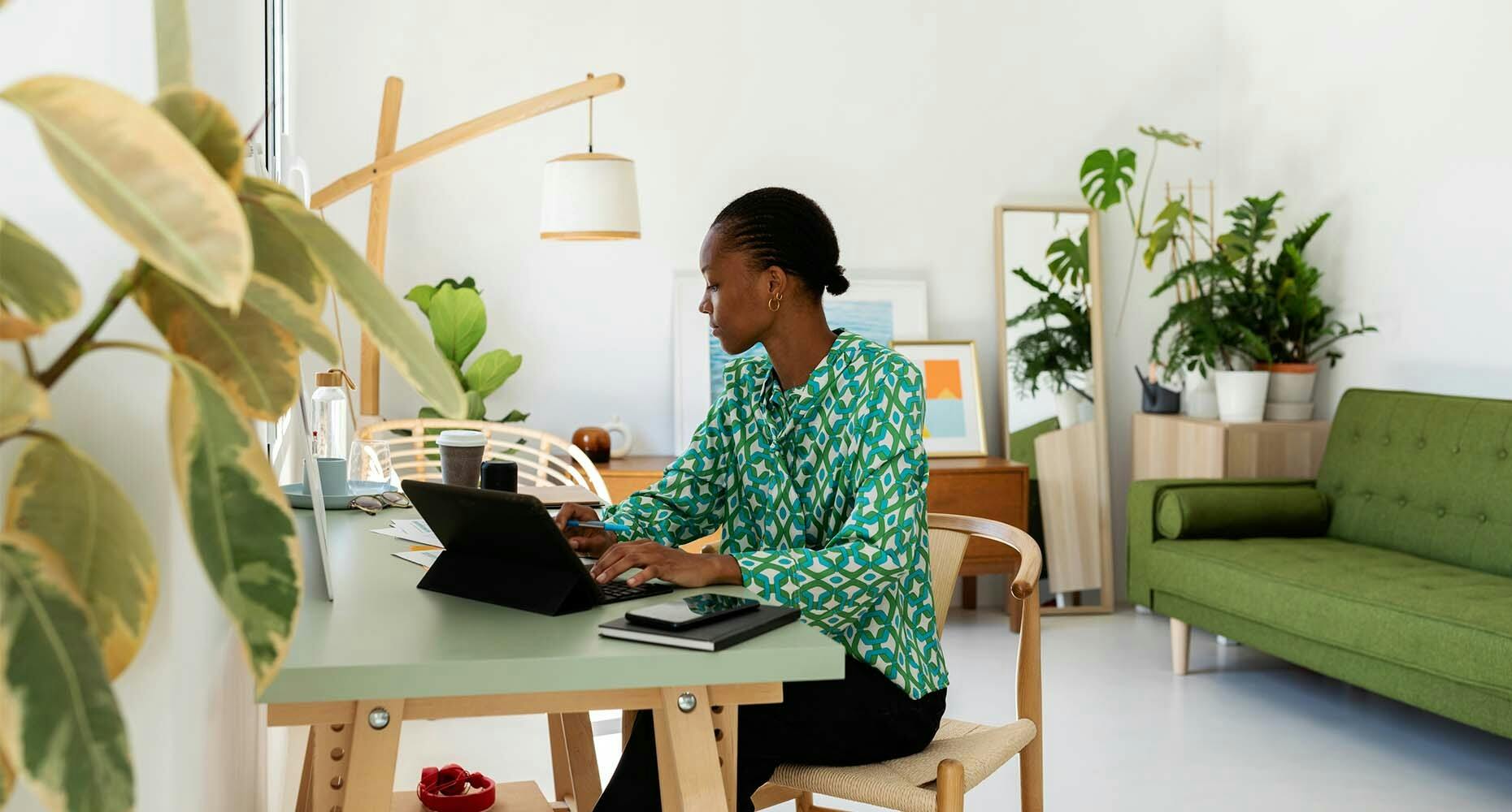 Woman working in a white walled home office