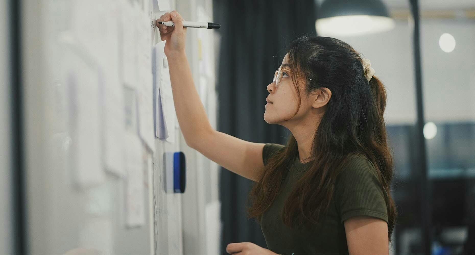 Woman working on a whiteboard
