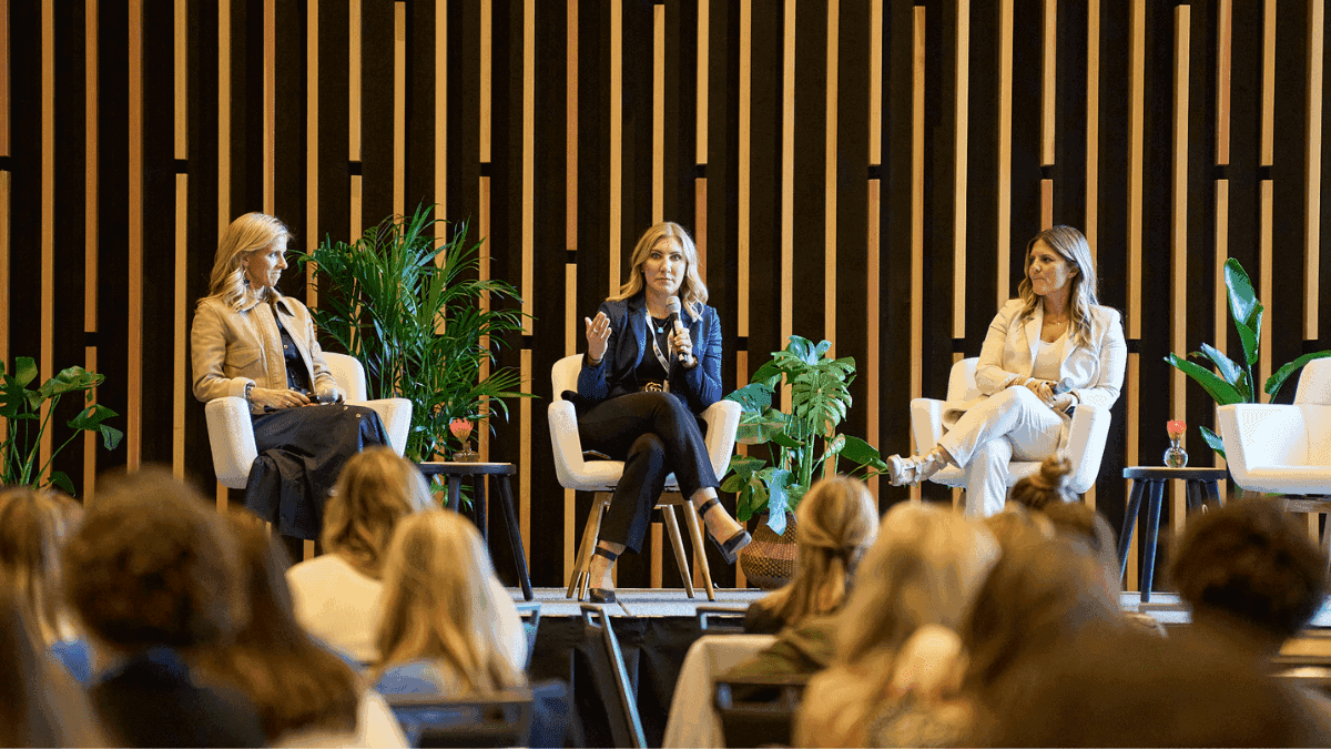 women having a panel discussion in front of a group